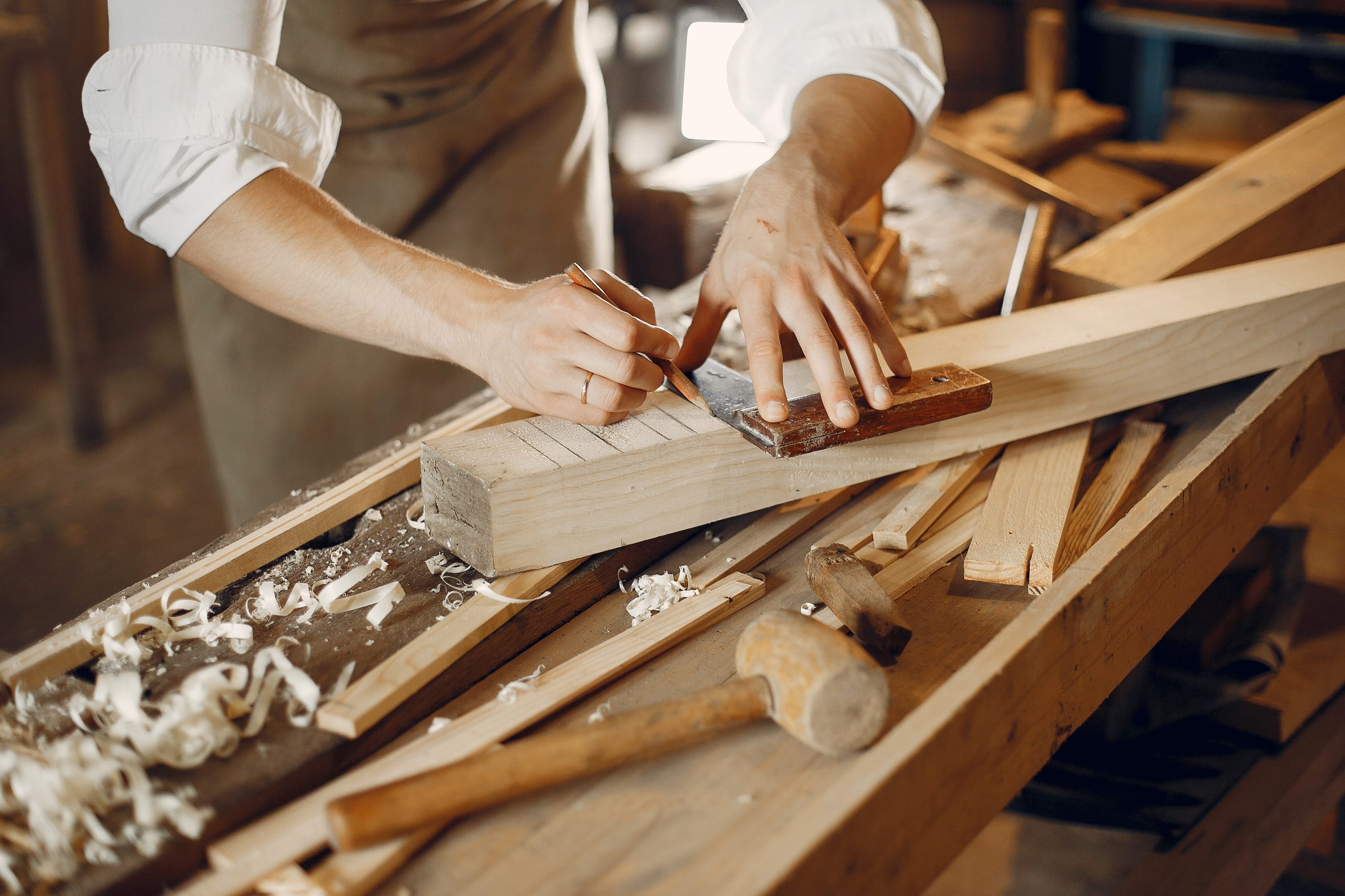 Handsome carpenter working with a wood